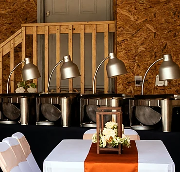 Buffet line with heat lamps at an event set by Ponnus Caters & Events